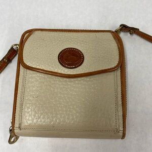 Dooney and Bourke brand all weather leather mini purse. Color: cream and brown